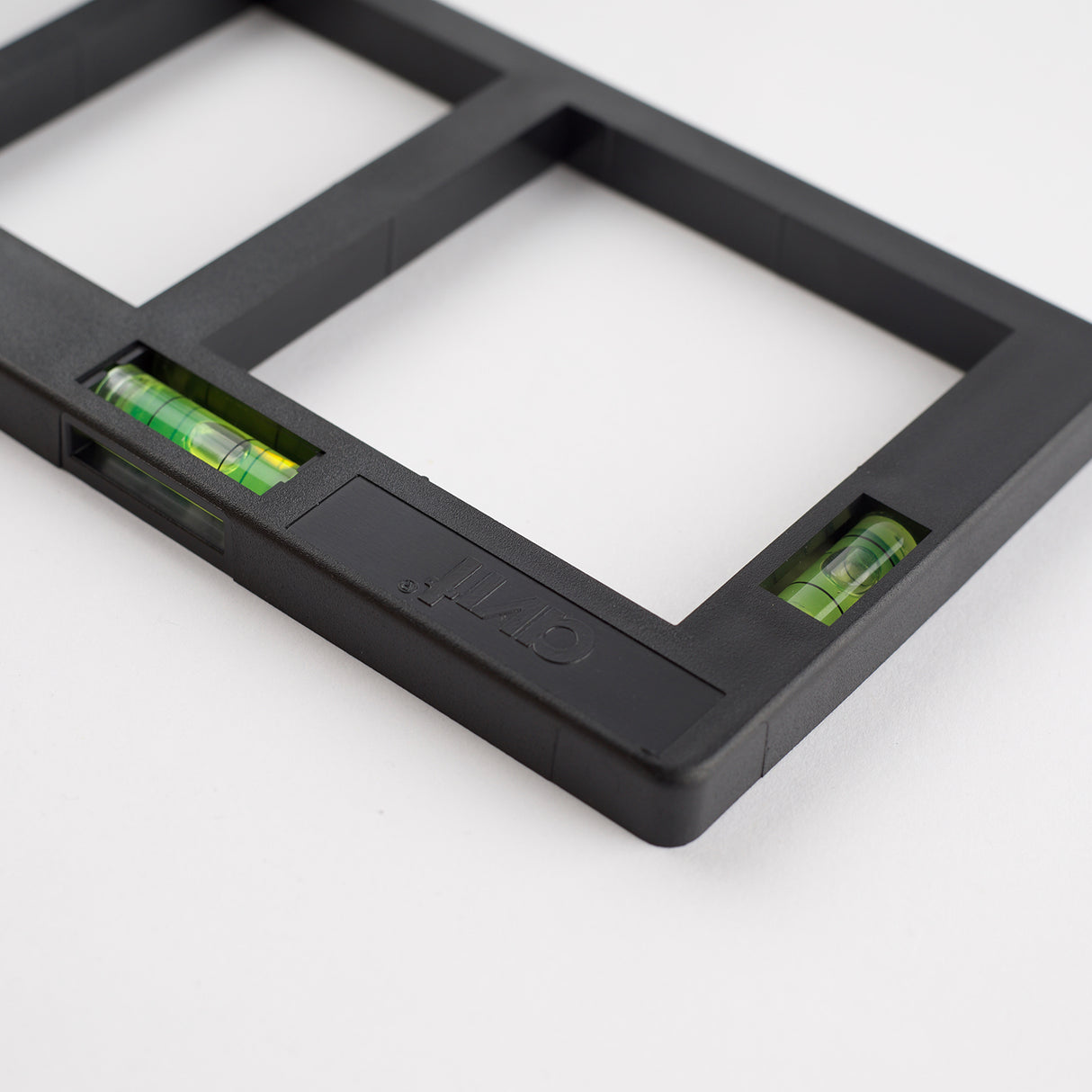 Close up of level indicators on a black AV02034 socket box template, branded avit on a white background